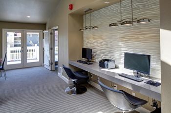 Resident Business Center with a desk with two computers and chairs at 2000 Lake Washington Apartments, Washington, 98056